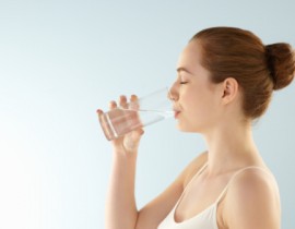Young woman drinking glass of water.